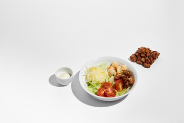 Deconstructed Caesar salad ingredients with neat geometry isolated on white background