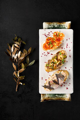 Diverse Bruschetta Assortment: Crab, Salmon with Avocado, and Roast Beef on Elegant Plates - 788216185