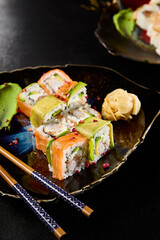 Diverse Individuals Enjoying Sushi Rolls with Salmon, Shrimp, and Avocado in a Casual Dining Setting - 788217511