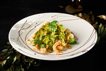 Delicious Spinach Fettuccine Pasta with Salmon and Shrimp on Elegant Plate - 788218177