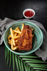 Chicken tenders with french fries in bowl on black backdrop. Junk food on dark stone background. Crispy chiken fillet with potatoes in minimal style. Combo with fried chicken breast and potatoes. - 788218583