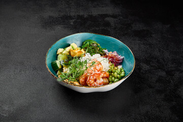 Poke bowl with shrimps and vegetables on black concrete background. Ahi poke with shrimp, rice, edamame and unagi sauce. Prawns poke bowl in minimal style on black background. Salad bowl with prawn. - 788218756