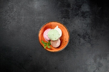 Assorted ice cream in ceramic bowl on black concrete background. Balls ice cream in minimal style. Assorted taste of ice cream: chocolate, strawberry, pistachio, vanilla. - 788219337