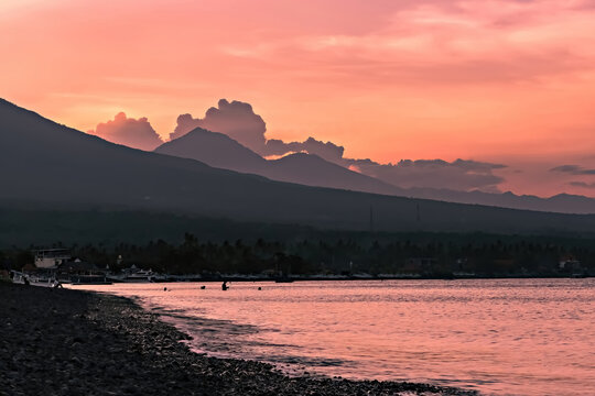 Breathtaking sunset view on Agung volcano from Amed beach in Bali, Indonesia