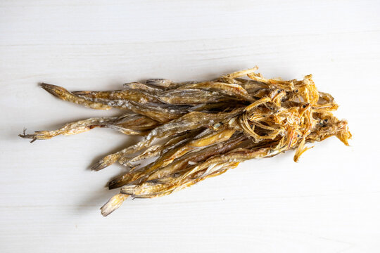 Dried sea fish Bombay duck (Harpadon nehereus) on wooden background. It is also known as bummalo, bombil, bombili, boomla, lotey. Locally In Bangladesh, It is called Loitta Shutki. Top view