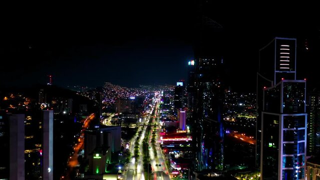 Aerial Forward Time Lapse Shot Of Traffic On Illuminated Streets In City Against Sky At Night - Monterrey, Mexico