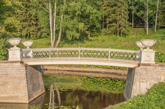 An ancient openwork bridge in a summer park