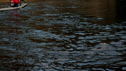 Canoeing, a type of rowing sport, follow of dual kayak going down the river. Aerial drone bird's eye view video of sport canoe operated by team. Sport Canoe with a team people rowing on tranquil water