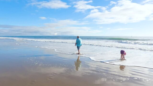 Father, Daughter Stroll El Capitan Beach, California