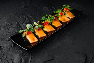Gourmet smoked salmon appetizer on dark background