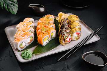 Assorted sushi platter on dark background