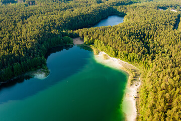 Aerial view of beautiful green waters of lake Gela. Birds eye view of scenic emerald lake...