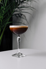 Elegant espresso martini cocktail on white table