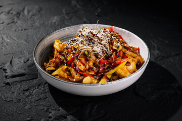 Spicy asian noodle dish on dark background