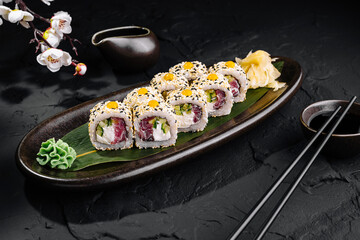 Exquisite sushi roll platter on dark background