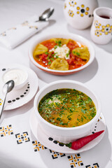 Traditional soup and pasta on elegant table setting
