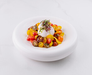 Gourmet burrata cheese salad on white plate