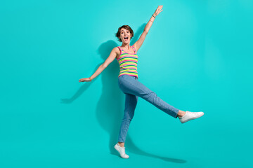 Fototapeta na wymiar Full body photo of carefree cheerful lady good mood rejoice enjoy dancing isolated on teal color background