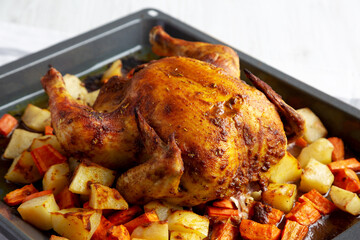 Homemade Hearty Roasted Chicken on Tray, side view.