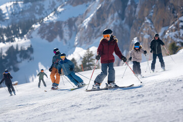 Multicultural families enjoying skiing together