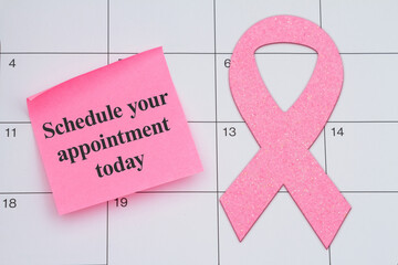 Schedule your appointment today for your mammogram with pink ribbon and sticky note on a calendar - 788257900