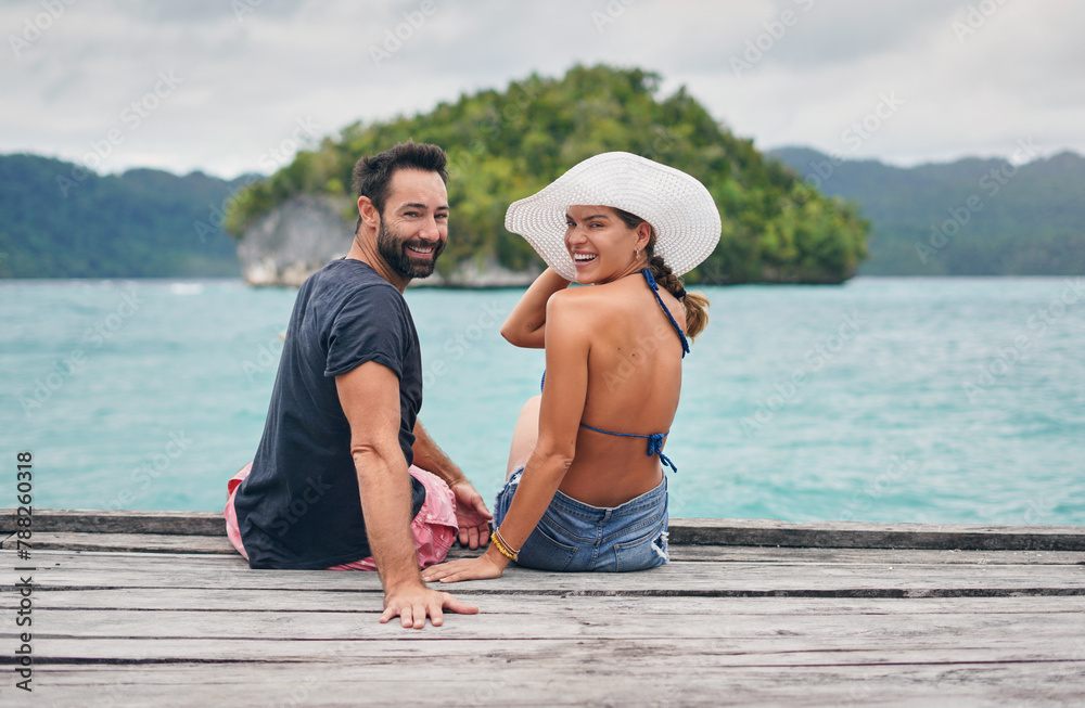 Sticker Water, travel and portrait of couple on dock with smile for honeymoon, vacation and romance. Man, woman and sitting on wooden pier with love for tropical island, holiday and weekend trip in Maldives