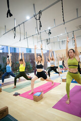 A group of women are practicing yoga in a studio