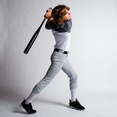 Male youth baseball player swinging a bat, hitting a home run