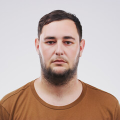 Fototapeta premium Portrait, mugshot and man in studio for arrest, political activism or human rights with white background. Activist, serious and face of male person for Ukraine conflict, justice or stop war in Russia