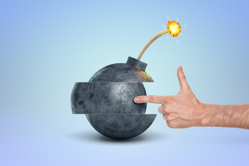 Hand pointing at a cartoon bomb with fuse