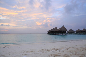 Over water island bungalows at sunset on Dominican republic