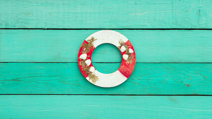 lifebuoy on the turquoise wall. Creative summer composition. Flat lay