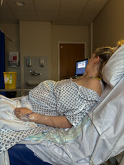 A woman in labour on her hospital bed at the delivery suite.