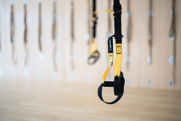 A yellow and black strap hangs from the ceiling