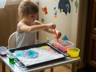 a child makes experiments with chemicals. experiments with soda and citric acid