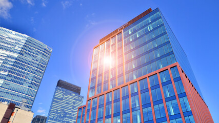 Glass building with transparent facade of the building and blue sky. Structural glass wall...