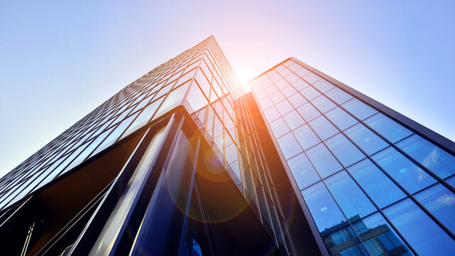 Steel and glass. The subject of modern architecture or construction industry. Modern office building facade with tall steel construction elements and full height windows between.