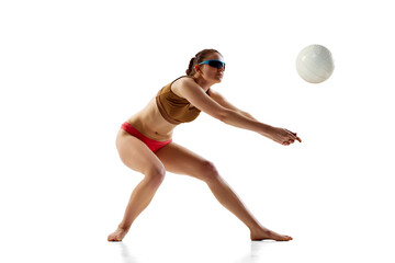 Sportswoman crouched in ready position to hitting ball, make low pass against white background....