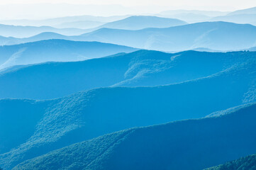 Sunrise in beautiful Carpathian mountains. Blue mountains texture