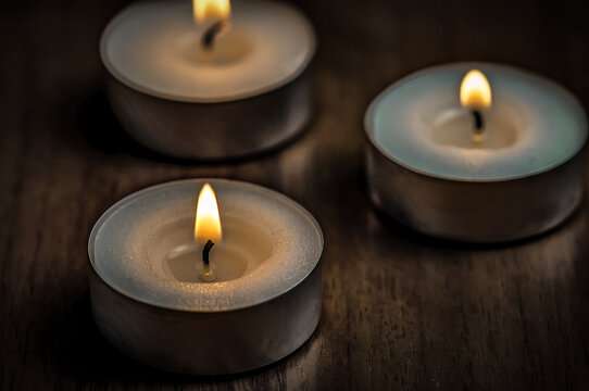 Three burning candles on the table