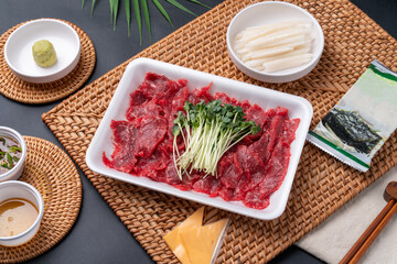 Korean food, Korean beef, beef sashimi,  beef sashimi, raw pork belly, charcoal fire, seasoning, ribs, side dishes, galbitang, rice, kimchi, ssamjang, chili peppers, garlic, radish sprouts, lettuce