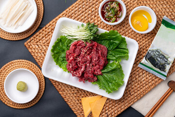 Korean food, Korean beef, beef sashimi,  beef sashimi, raw pork belly, charcoal fire, seasoning, ribs, side dishes, galbitang, rice, kimchi, ssamjang, chili peppers, garlic, radish sprouts, lettuce