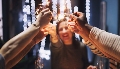 New Year, happy and people with sparklers at party for celebration, collaboration and social...