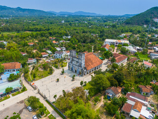 Fototapeta premium Aerial view of Mang Lang Catholic Church in ancient village in Phu Yen province, Vietnam. Travel and landscape concept