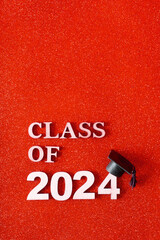 Class of 2024 text with graduation cap on glitter background. Graduation holiday concept.