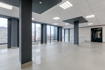 panorama view in empty modern hall with columns, doors, stairs and panoramic windows