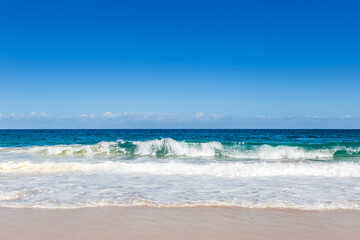 Fototapeta na wymiar Ocean Waves at Sand Beach of Shoal Bay, New South Wales, Australia.