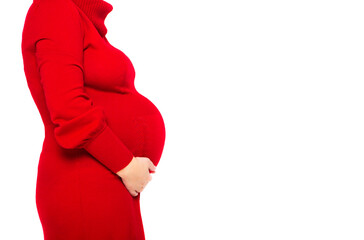Happy young pregnant woman in red dress touching her belly
