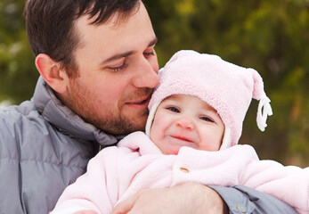 Happy smiling father with one year old baby girl