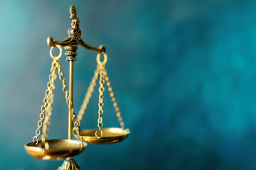 Golden Scales of Justice on a Blue Background Symbolizing Law and Balance